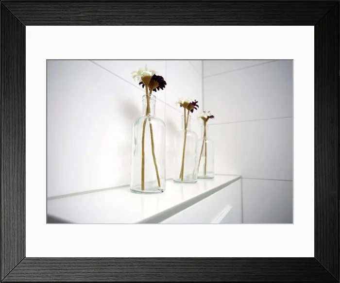 Framed Print : Three glass vases with daisies near white tiled wall in the bathroom Framed Print : Three glass vases with daisies near white tiled wall in the bathroom