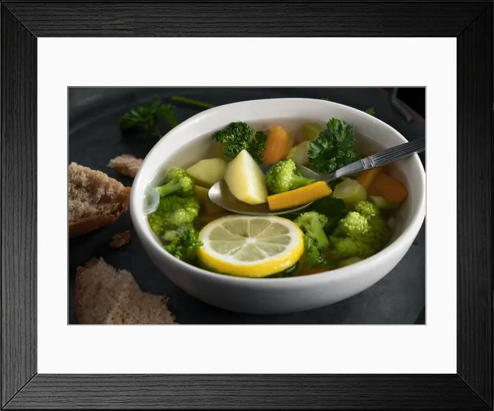 Framed Print : Vegetarian vegetable soup with carrots, broccoli and parsley in a light bowl on a metal tray on a wooden table Framed Print : Vegetarian vegetable soup with carrots, broccoli and parsley in a light bowl on a metal tray on a wooden table