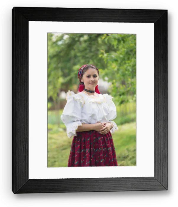 Framed Print : Portrait of a beautiful young woman wearing traditional Romanian clothes, in Maramures Framed Print : Portrait of a beautiful young woman wearing traditional Romanian clothes, in Maramures
