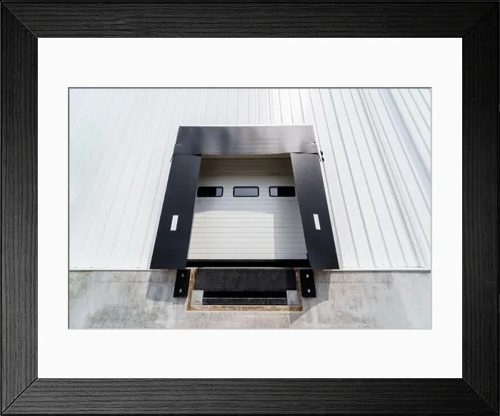 Framed Print : Warehouse gate for loading and unloading cargo in a distributed center Framed Print : Warehouse gate for loading and unloading cargo in a distributed center