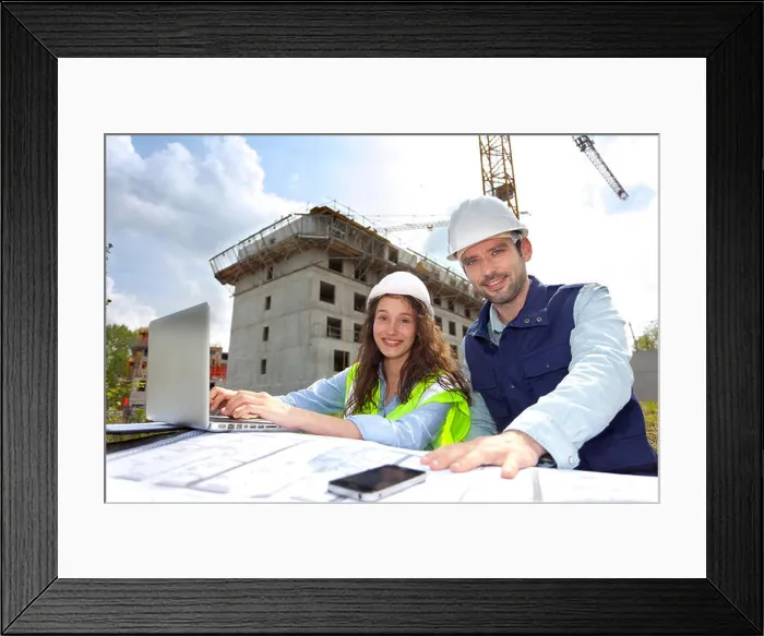 Framed Print : View of Co-workers working on a construction site Framed Print : View of Co-workers working on a construction site