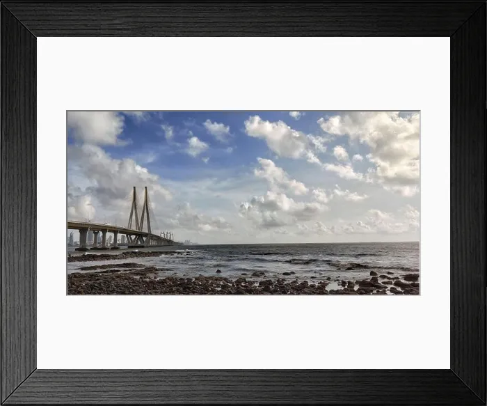 Framed Print : Bottom view to Bandra Worli Sea Link bridge through the rocky beach under fluffy clouds, Mumbai, India Framed Print : Bottom view to Bandra Worli Sea Link bridge through the rocky beach under fluffy clouds, Mumbai, India