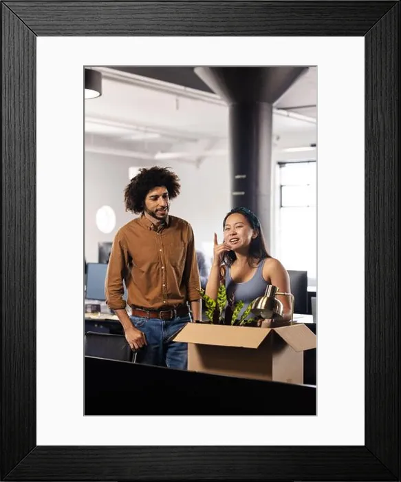 Framed Print : Diverse colleagues discussing office move while unpacking box with desk lamp and plant, copy space Framed Print : Diverse colleagues discussing office move while unpacking box with desk lamp and plant, copy space