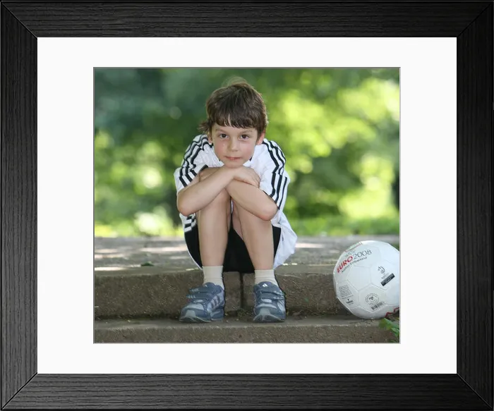 Framed Print : Seven-year-old Felix Prengel poses with a football in Munich Framed Print : Seven-year-old Felix Prengel poses with a football in Munich