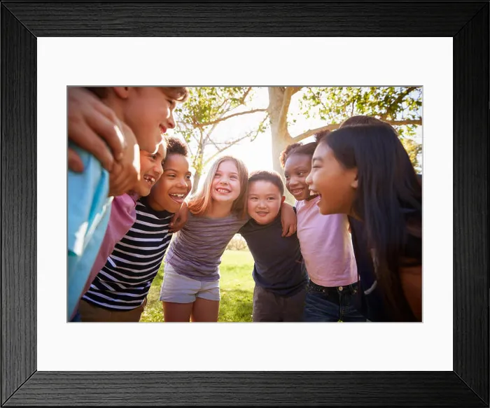 Framed Print : Group of schoolchildren embrace standing in a circle Framed Print : Group of schoolchildren embrace standing in a circle