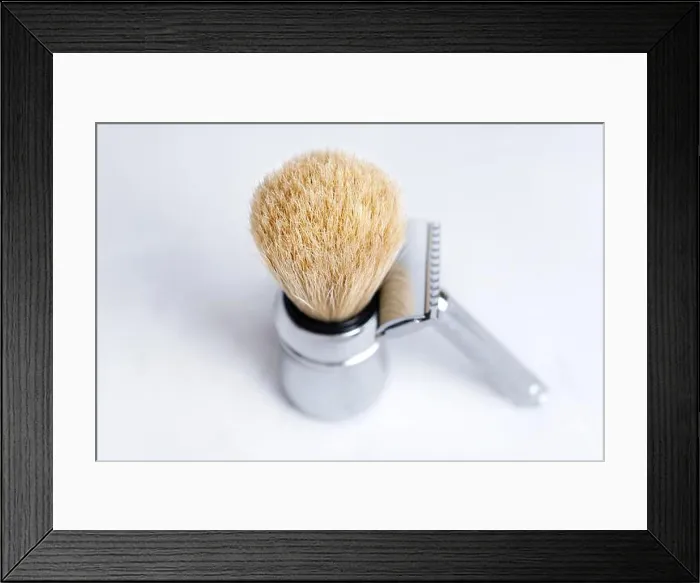 Framed Print : Chrome-plated safety razor and shaving brush isolated on light gray background Framed Print : Chrome-plated safety razor and shaving brush isolated on light gray background