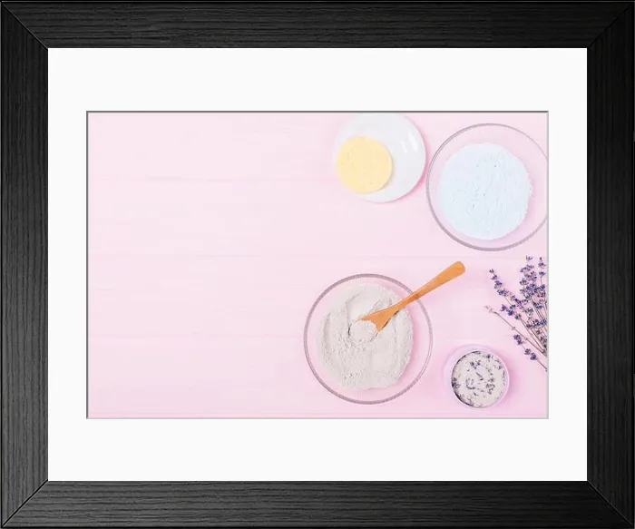 Framed Print : Flat lay cosmetic clay powder in bowl next to lavender flowers on wooden pink table with free space Framed Print : Flat lay cosmetic clay powder in bowl next to lavender flowers on wooden pink table with free space