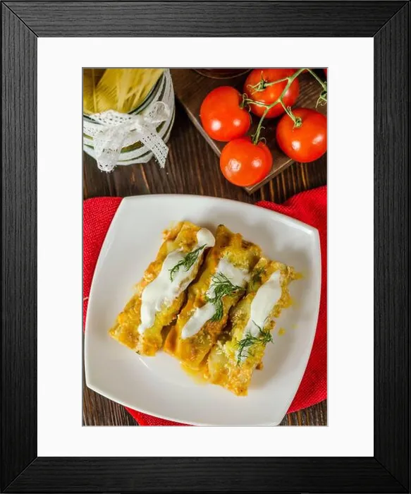 Framed Print : Cannelloni with meat filling in a cream sauce on a plate Framed Print : Cannelloni with meat filling in a cream sauce on a plate
