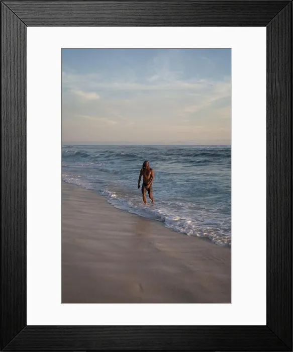 Framed Print : An Arab man with long curly hair swims in the ocean
