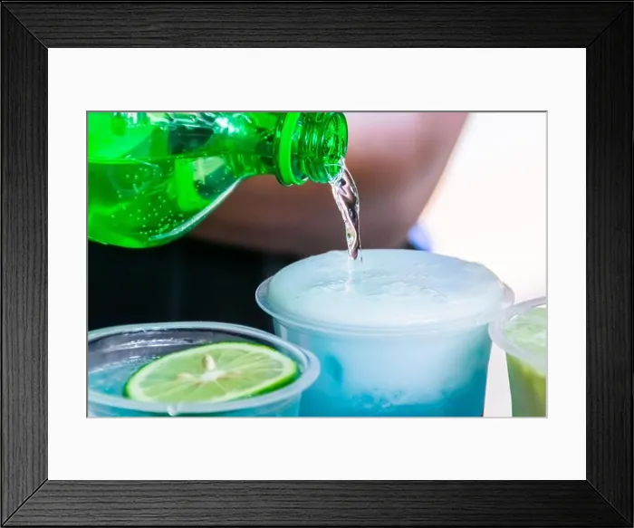 Framed Print : Pouring a soda water into a transparent plastic glass with cold shaved ice inside Framed Print : Pouring a soda water into a transparent plastic glass with cold shaved ice inside