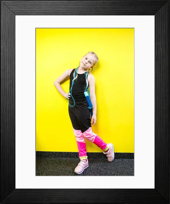 Framed Print : Theme sport and health. Beautiful caucasian child girl with pigtails posing yellow background with smile Framed Print : Theme sport and health. Beautiful caucasian child girl with pigtails posing yellow background with smile