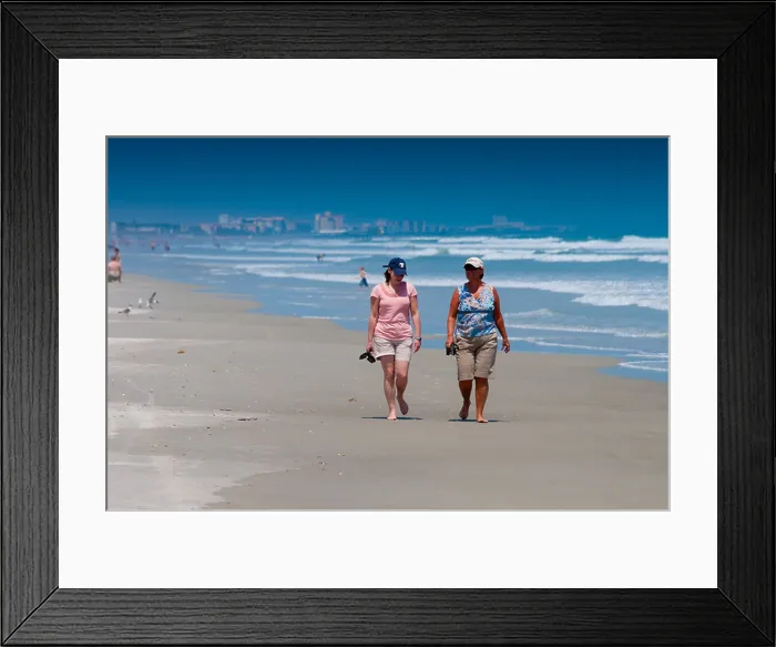 Framed Print : Two ladies walking along the Cocoa beach In Florida Framed Print : Two ladies walking along the Cocoa beach In Florida