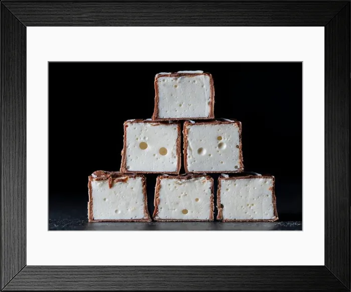 Framed Print : Chocolate candy stuffed vanilla souffle on a black background, close up. Candy name Bird's milk, delicate dessert Framed Print : Chocolate candy stuffed vanilla souffle on a black background, close up. Candy name Bird's milk, delicate dessert