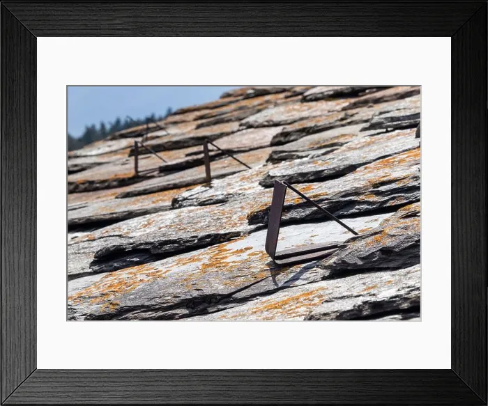 Framed Print : Close up view of old metal snow guards on a slate roof in the Italian Alps Framed Print : Close up view of old metal snow guards on a slate roof in the Italian Alps
