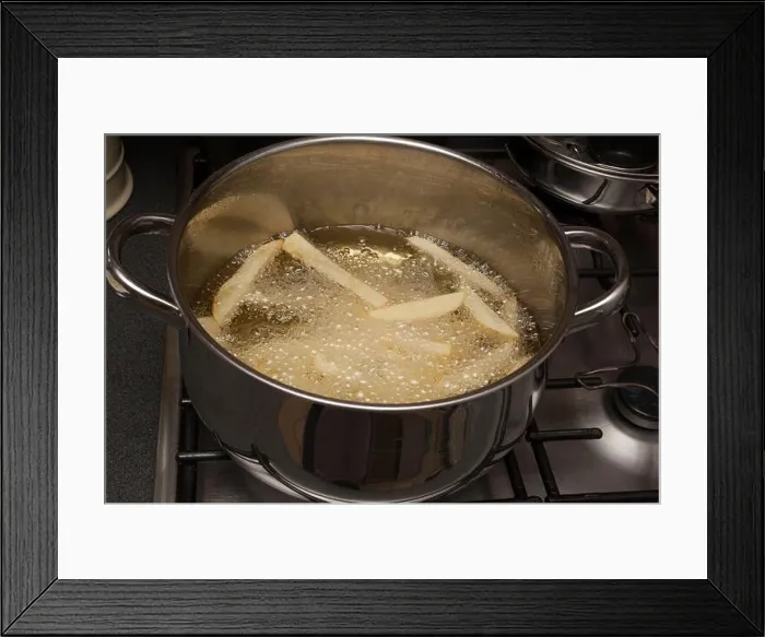 Framed Print : Homemade potato chips frying in a pan of hot oil Framed Print : Homemade potato chips frying in a pan of hot oil