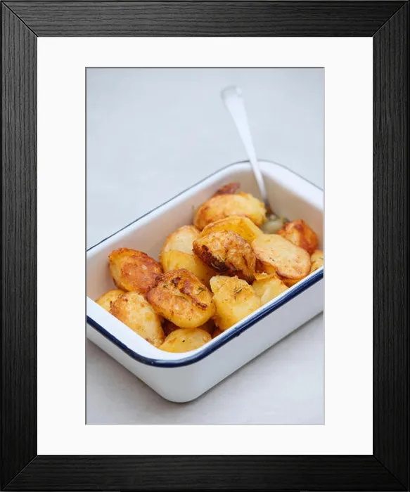Framed Print : Roast potatoes in an white enamel roasting dish on a white background Framed Print : Roast potatoes in an white enamel roasting dish on a white background