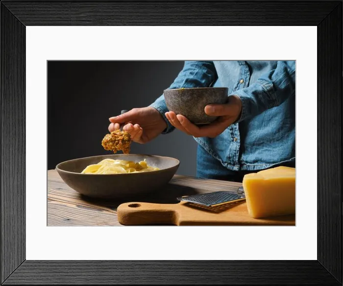 Framed Print : Low key photo of unrecognizable woman serve vegetable sauce in plate with pasta Framed Print : Low key photo of unrecognizable woman serve vegetable sauce in plate with pasta