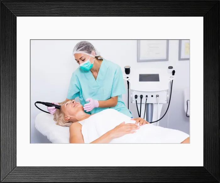 Framed Print : Beautician doing innovative procedure of cryoliposuction to female in cosmetic office Framed Print : Beautician doing innovative procedure of cryoliposuction to female in cosmetic office