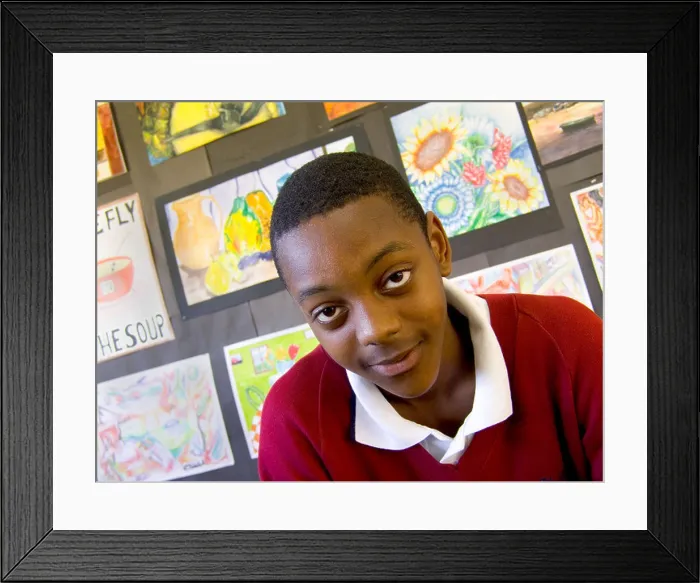 Framed Print : Schoolboy classroom portrait of a confident 13-15 years teenage black boy in school art classroom with his paintings Framed Print : Schoolboy classroom portrait of a confident 13-15 years teenage black boy in school art classroom with his paintings