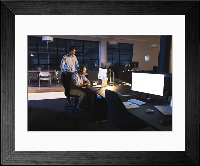 Framed Print : Business diverse professionals collaborating on project in modern office during night Framed Print : Business diverse professionals collaborating on project in modern office during night