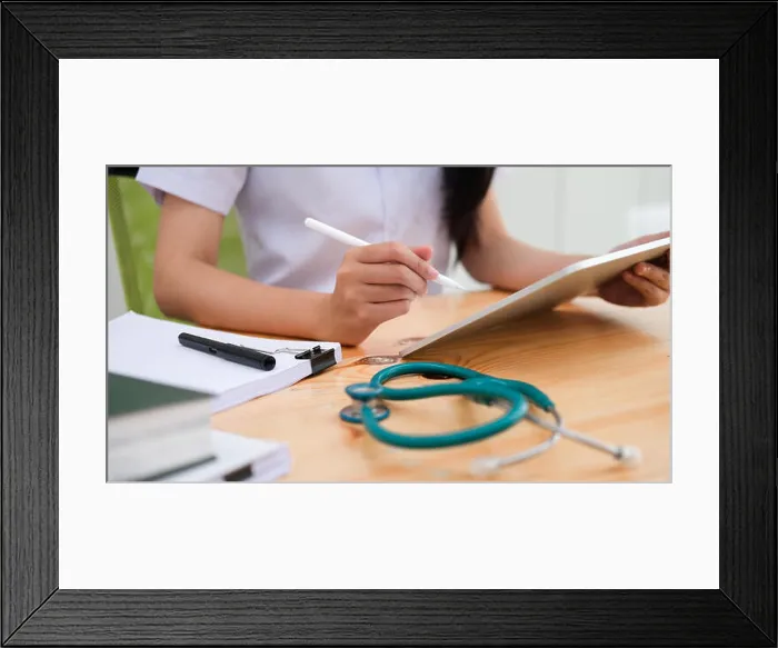 Framed Print : Close up doctor examining medical report while using computer tablet. Medical and healthcare concept Framed Print : Close up doctor examining medical report while using computer tablet. Medical and healthcare concept