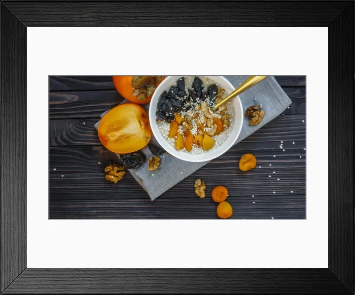 Framed Print : Oatmeal with Persimmon, Prune, Dried Apricots, Walnut and Sesame on a Black Wooden Table Top View Copy Space Background Framed Print : Oatmeal with Persimmon, Prune, Dried Apricots, Walnut and Sesame on a Black Wooden Table Top View Copy Space Background