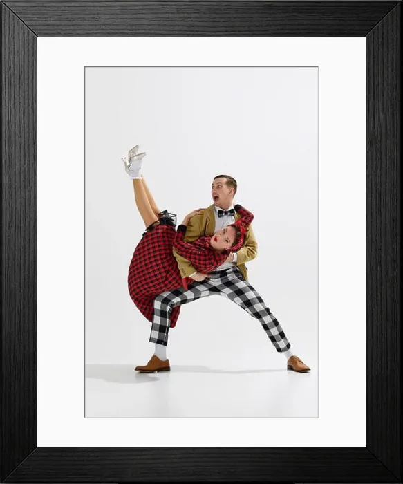 Framed Print : Joyous young couple in vintage attire, man and woman cheerfully dancing isolated over white studio background Framed Print : Joyous young couple in vintage attire, man and woman cheerfully dancing isolated over white studio background