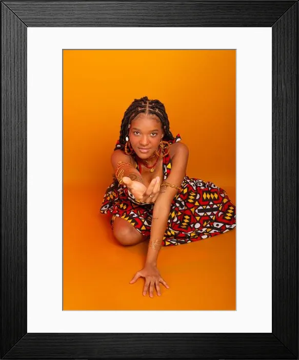 Framed Print : Beautiful young woman sitting with braids in her hair wearing traditional clothing Framed Print : Beautiful young woman sitting with braids in her hair wearing traditional clothing