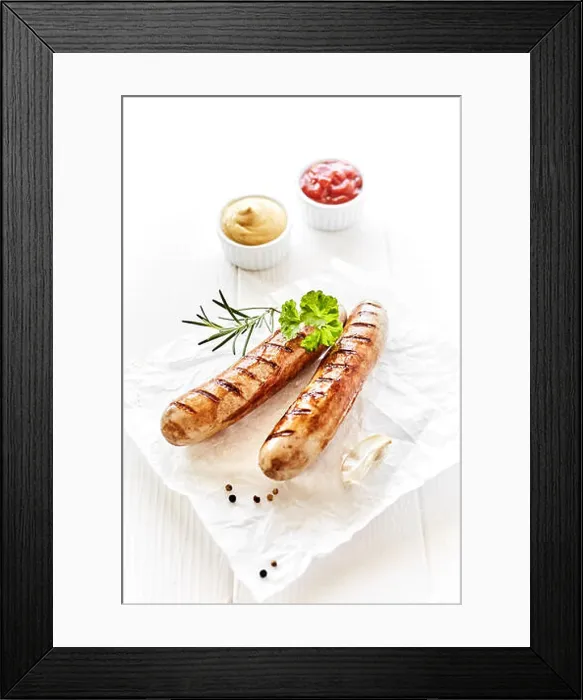 Framed Print : Portion of two grilled sausages served on white napkin with spices and fresh parsley on wooden white table Framed Print : Portion of two grilled sausages served on white napkin with spices and fresh parsley on wooden white table