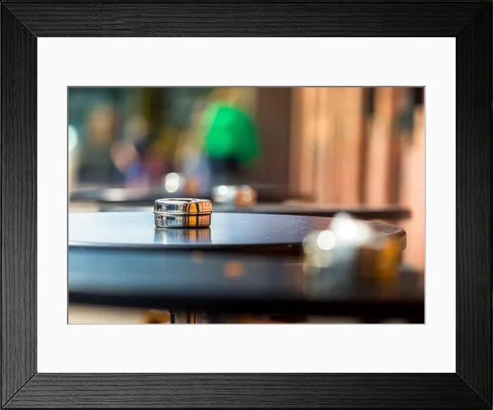 Framed Print : An ashtray placed on a round wooden table outdoors, shallow DOF Framed Print : An ashtray placed on a round wooden table outdoors, shallow DOF