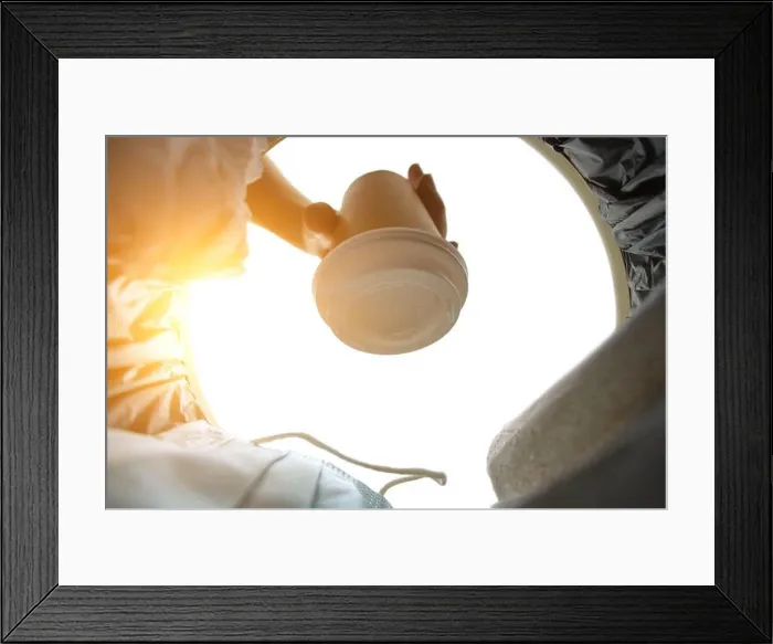Framed Print : Man throws a disposable coffee cup into trash.Cleanliness and care for environment.View from inside Framed Print : Man throws a disposable coffee cup into trash.Cleanliness and care for environment.View from inside