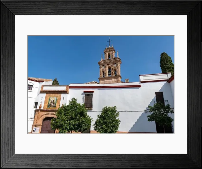 Framed Print : The belfry of the 15th century Monasterio de Santa Paula towers over the ornate façade of the convent on Calle Santa