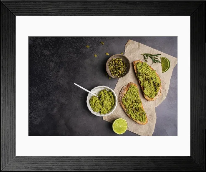 Framed Print : Toast with fresh avocado, herbs and seeds with lemon slices on dark background Framed Print : Toast with fresh avocado, herbs and seeds with lemon slices on dark background