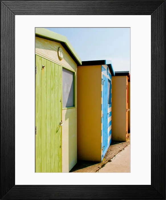 Framed Print : A line of beach huts on the seashore at Seaford, East Sussex Framed Print : A line of beach huts on the seashore at Seaford, East Sussex