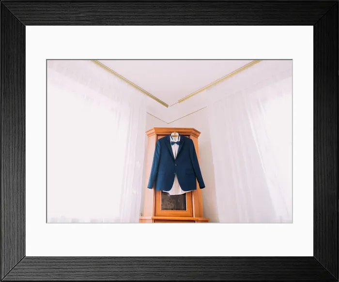 Framed Print : Excellent expensive blue suit hanging in the interior of hotel room Framed Print : Excellent expensive blue suit hanging in the interior of hotel room