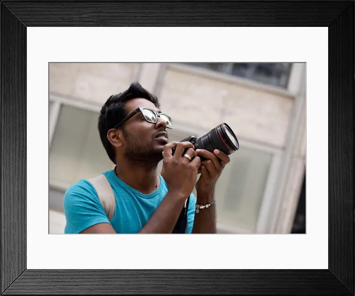 Framed Print : young photographer holding a camera