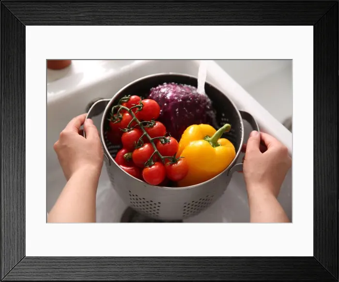 Framed Print : Woman washing fresh vegetables in kitchen sink, closeup Framed Print : Woman washing fresh vegetables in kitchen sink, closeup