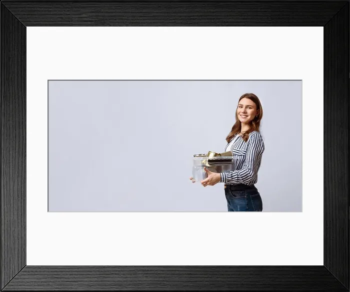 Framed Print : Eco-conscious woman participates in recycling during a sunny afternoon Framed Print : Eco-conscious woman participates in recycling during a sunny afternoon