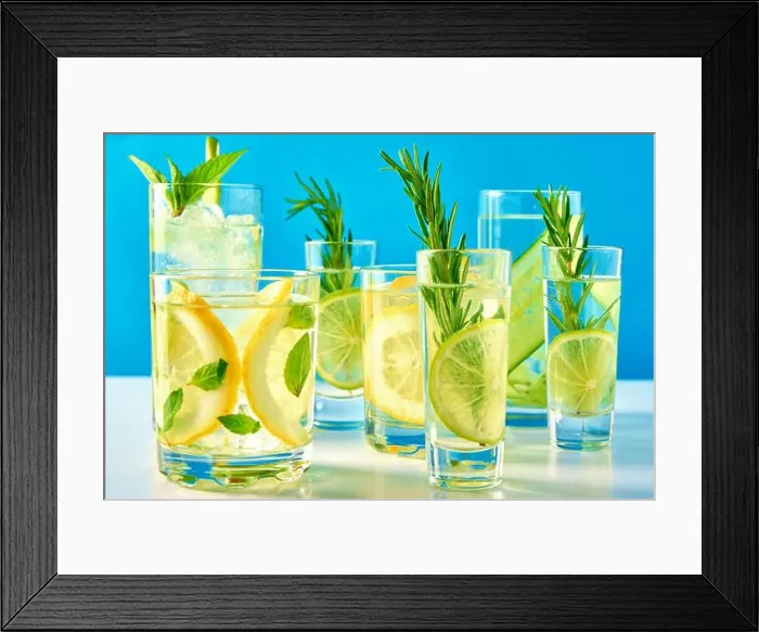 Framed Print : Summer alcoholic cocktail. Refreshment lemon soda drink. Gin and tonic with lime and rosemary on blue background Framed Print : Summer alcoholic cocktail. Refreshment lemon soda drink. Gin and tonic with lime and rosemary on blue background