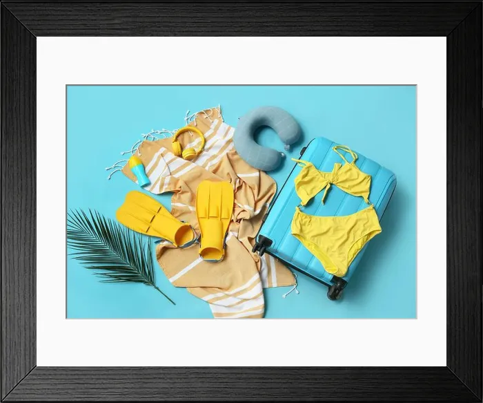 Framed Print : Composition with suitcase, swimsuit, paddles and beach accessories on blue background Framed Print : Composition with suitcase, swimsuit, paddles and beach accessories on blue background