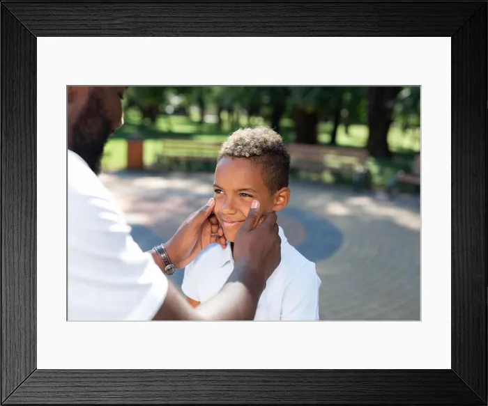 Framed Print : Nice caring father touching his sons cheeks Framed Print : Nice caring father touching his sons cheeks