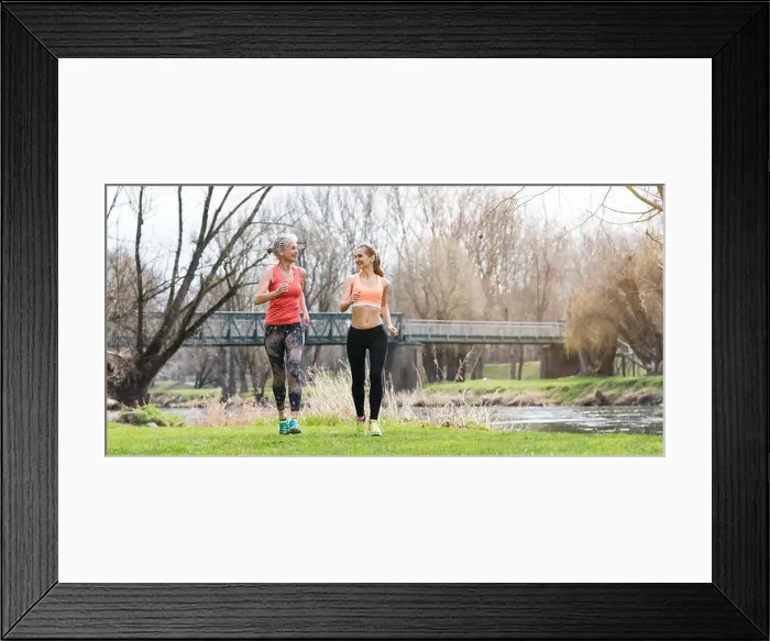 Framed Print : Senior and young woman running as sport on a meadow in spring Framed Print : Senior and young woman running as sport on a meadow in spring