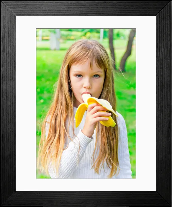 Framed Print : Photo of girl are eating banana in summer Framed Print : Photo of girl are eating banana in summer
