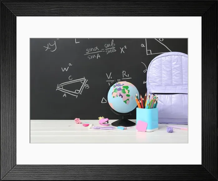 Framed Print : Backpack, stationery and globe on white table against green chalkboard with formulas Framed Print : Backpack, stationery and globe on white table against green chalkboard with formulas