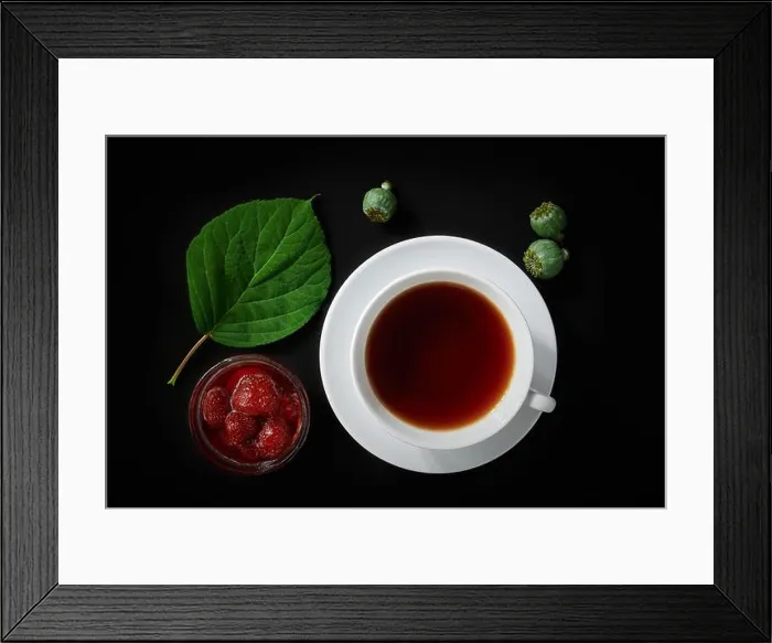 Framed Print : White cup with tea, strawberry jam, poppy boxes and hydrangea leaf on dark background, top view, still life Framed Print : White cup with tea, strawberry jam, poppy boxes and hydrangea leaf on dark background, top view, still life