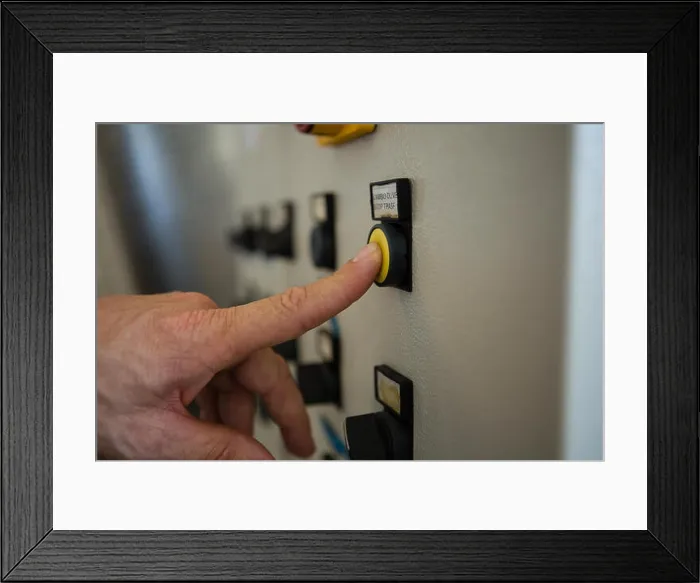 Framed Print : Hand pressing a control button in factory Framed Print : Hand pressing a control button in factory