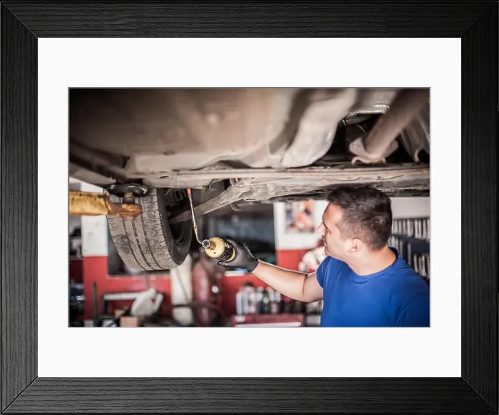 Framed Print : Car master mechanic repairer heating the screws with butane gas blow mini welding torch flamethrower burner in vehicle Framed Print : Car master mechanic repairer heating the screws with butane gas blow mini welding torch flamethrower burner in vehicle
