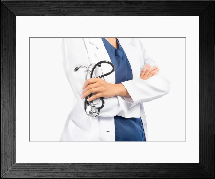 Framed Print : Woman doctor in white lab coat holding stethoscope on her hands isolated over white background Framed Print : Woman doctor in white lab coat holding stethoscope on her hands isolated over white background