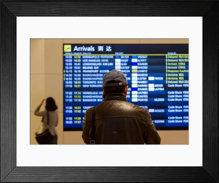 Framed Print : A man in a baseball caps looks at the Arrivals Board in Haneda International Airport, Tokyo, Japan Framed Print : A man in a baseball caps looks at the Arrivals Board in Haneda International Airport, Tokyo, Japan