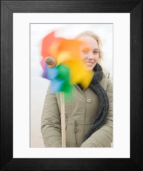 Framed Print : Young woman with pinwheel Framed Print : Young woman with pinwheel